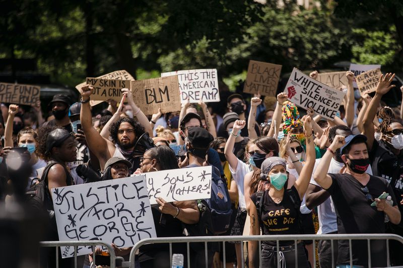 Figure 1: A crowd of diverse people stand with signs reading, “Justice for George Floyd,” “BLM,” “Is this the American dream?” “White silence is violence,” “My skin is not a crime,” and “defund the police.” Figure 1