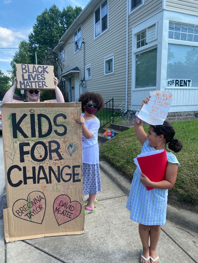 Figure 5: Children and adults gather with posters to protest police shootings of Black people in a Louisville neighborhood with signs reading, 'Kids for Change' and 'Black Lives Matter' in June 2020. Breonna Taylor and David McAtee's names are written in hearts. Figure 5