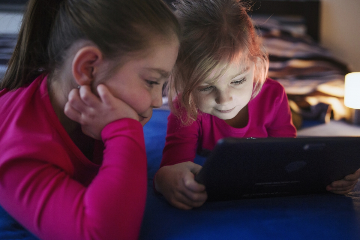 Picture 1: Two girls watching video on a tablet. Image 1: Two girls watching video on a tablet.